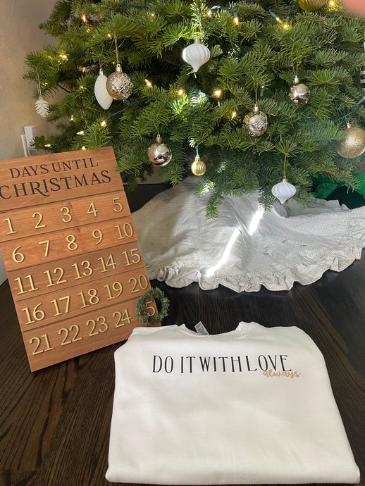 Do It With Love Sweatshirt Always Crewneck on the floor next to Christmas countdown and tree.